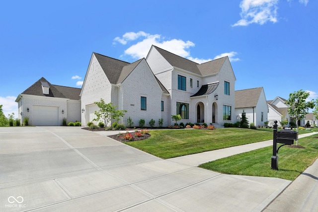 view of front of home with driveway, brick siding, and a front yard