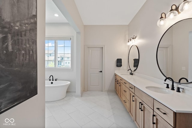 bathroom featuring double vanity, a soaking tub, baseboards, and a sink