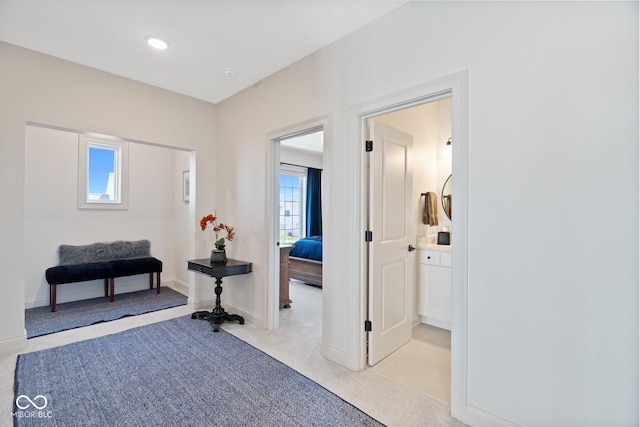 interior space featuring recessed lighting, light carpet, and baseboards