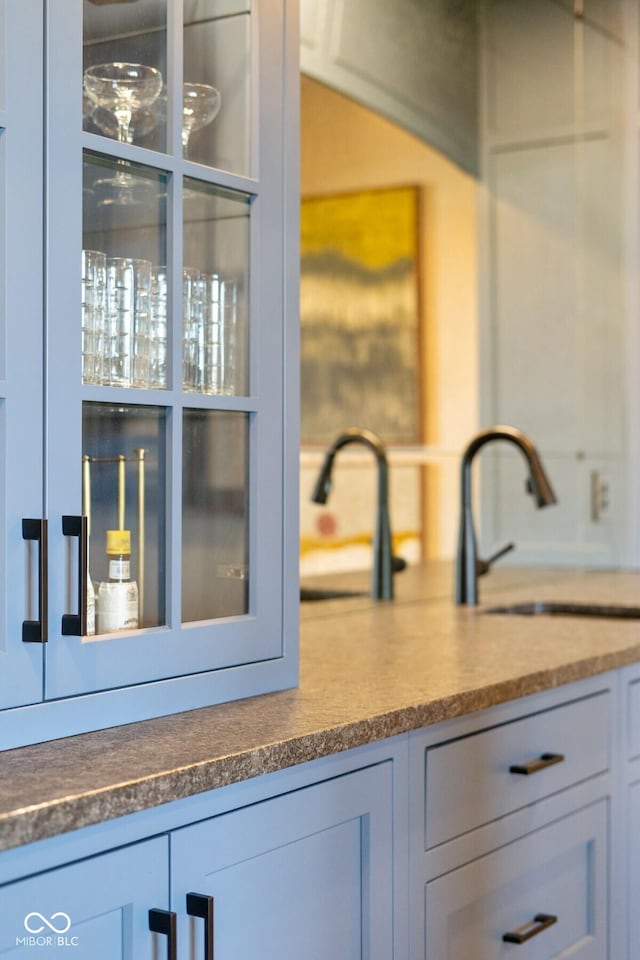 kitchen featuring dark countertops and a sink