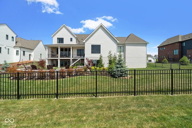 view of front of home with stairway, a balcony, a residential view, a fenced backyard, and a front lawn