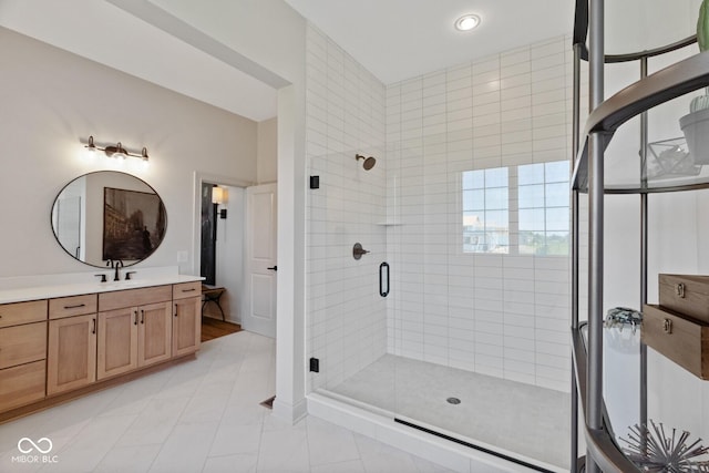 full bath featuring a stall shower, vanity, and tile patterned floors