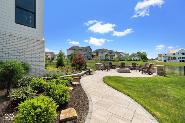 exterior space with a patio area, a residential view, a fire pit, and a lawn