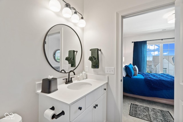 bathroom with vanity and ensuite bath