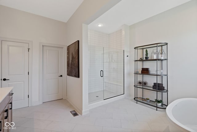 full bath with visible vents, baseboards, a freestanding bath, vanity, and a stall shower