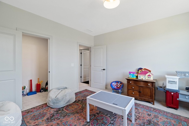 recreation room with light carpet