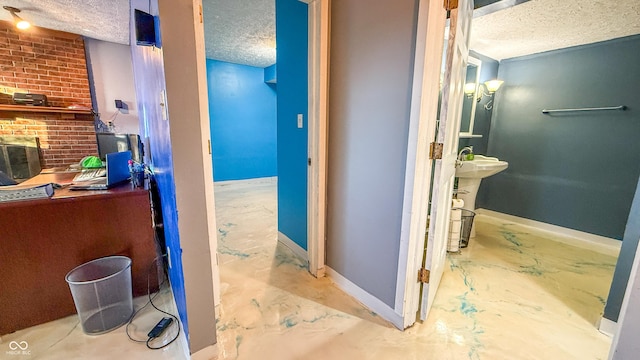 bathroom with a textured ceiling and concrete flooring