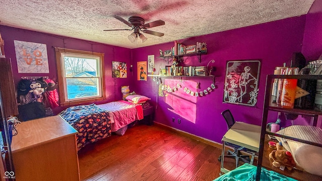 bedroom with ceiling fan, a textured ceiling, and hardwood / wood-style flooring