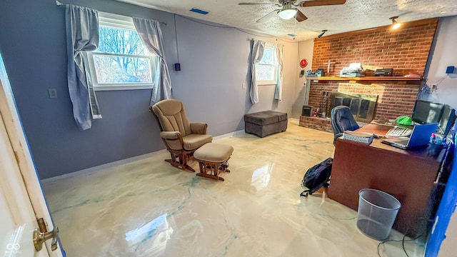 home office featuring a brick fireplace, a textured ceiling, ceiling fan, and concrete flooring