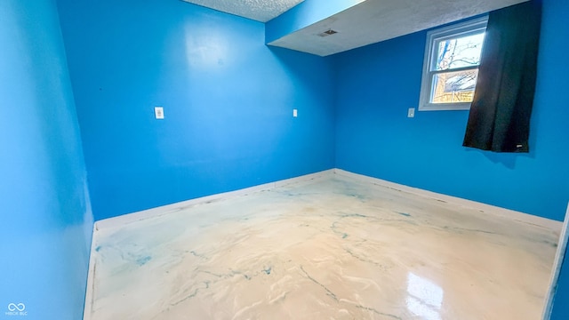 spare room featuring a textured ceiling