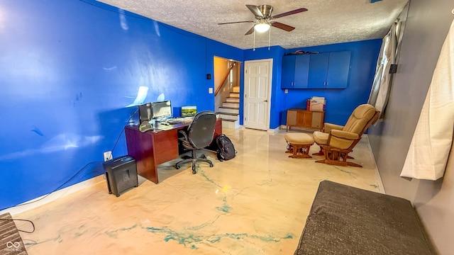 office area featuring ceiling fan and a textured ceiling