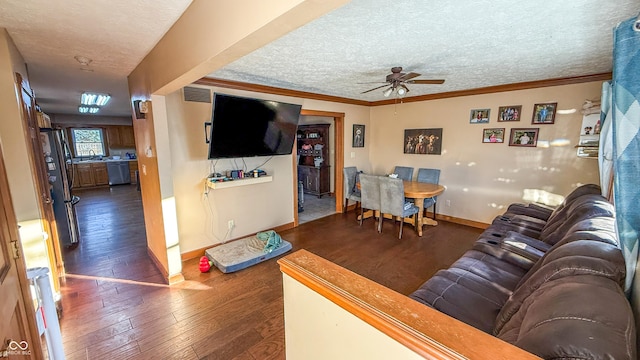 living room featuring ceiling fan, a textured ceiling, dark hardwood / wood-style floors, and ornamental molding