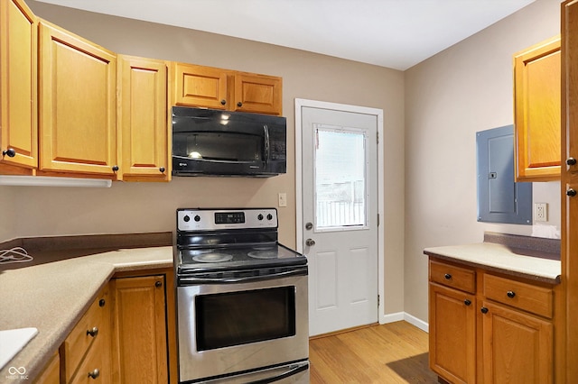 kitchen with stainless steel electric stove, electric panel, and light hardwood / wood-style flooring