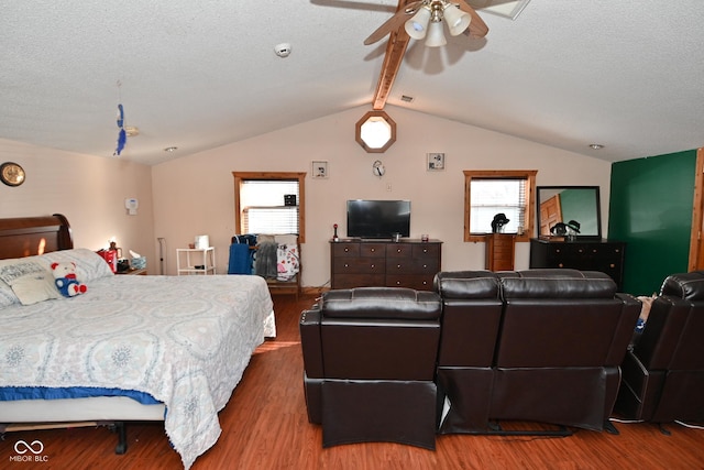 bedroom featuring hardwood / wood-style flooring, a textured ceiling, lofted ceiling with beams, and ceiling fan