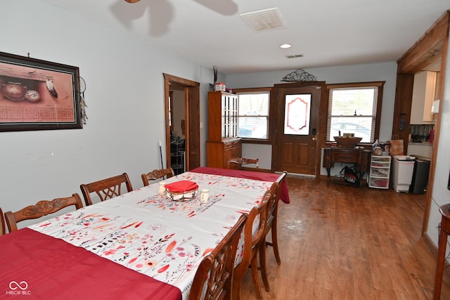 dining area with dark wood-type flooring and ceiling fan