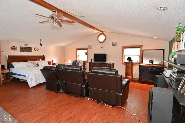 living room featuring a textured ceiling, ceiling fan, wood-type flooring, and lofted ceiling with beams