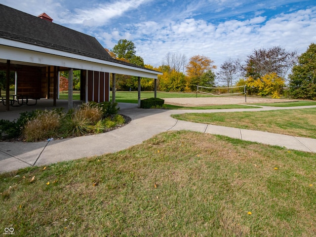 view of community featuring volleyball court and a lawn