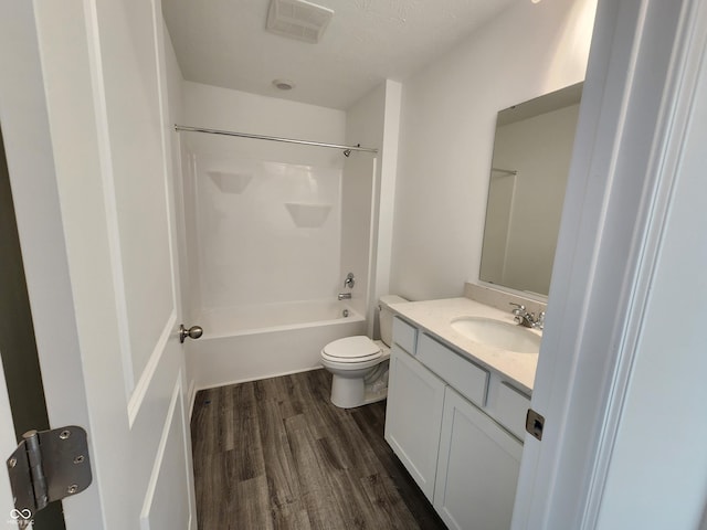 full bathroom featuring vanity, wood-type flooring, tub / shower combination, and toilet