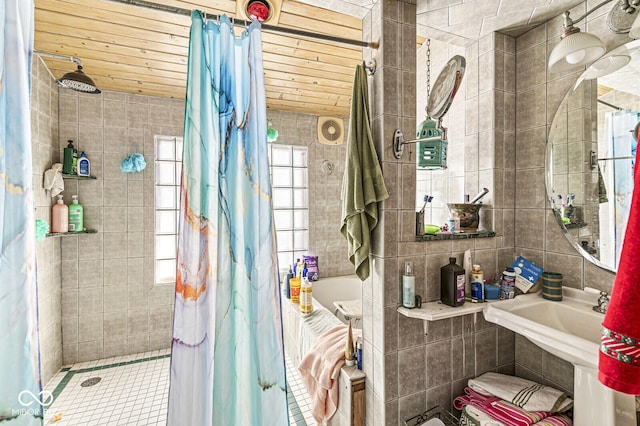 bathroom with curtained shower, wooden ceiling, and tile walls