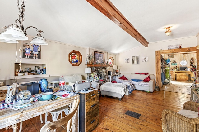 bedroom featuring hardwood / wood-style flooring and lofted ceiling with beams