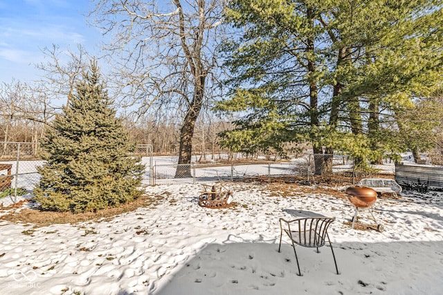 snowy yard featuring a fire pit