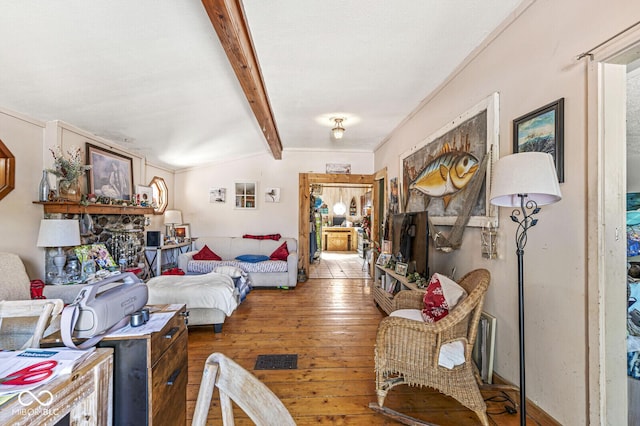 bedroom with hardwood / wood-style flooring and vaulted ceiling with beams