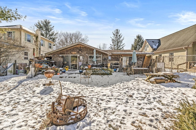 view of snow covered back of property