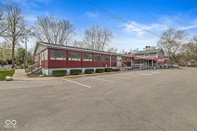 view of building exterior with uncovered parking
