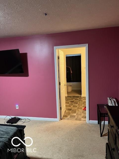 carpeted bedroom featuring a textured ceiling