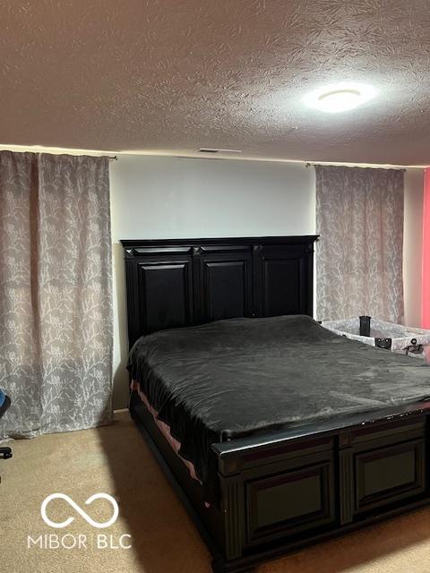 unfurnished bedroom with carpet floors and a textured ceiling