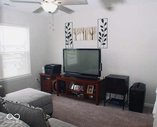 living room with ceiling fan and carpet