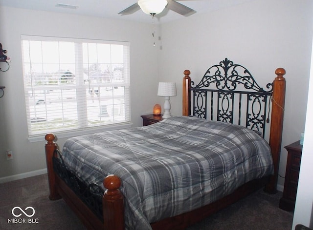 carpeted bedroom with ceiling fan and multiple windows