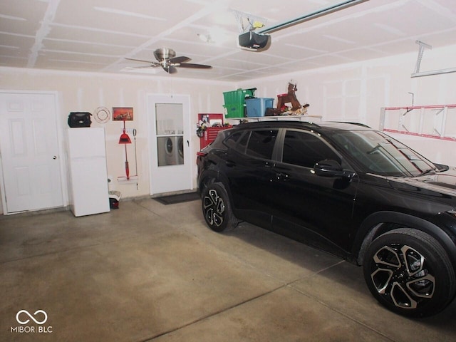 garage featuring a garage door opener and white fridge