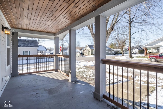 snow covered patio featuring covered porch