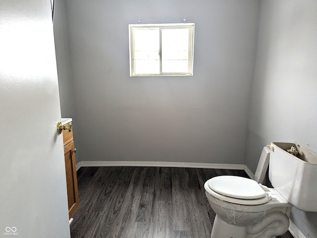 bathroom featuring toilet and wood-type flooring