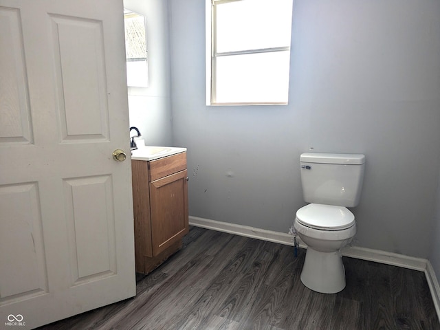 bathroom featuring toilet, wood-type flooring, and vanity