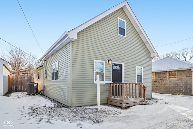 snow covered property featuring cooling unit