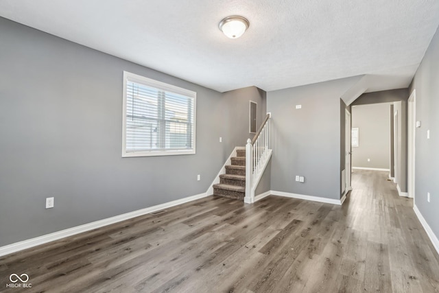 empty room featuring hardwood / wood-style floors and a textured ceiling