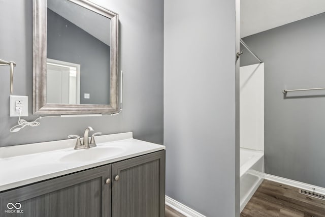 bathroom featuring hardwood / wood-style flooring and vanity