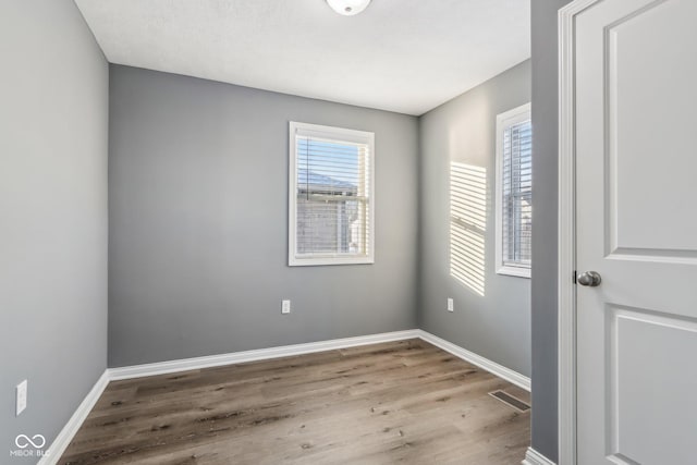 spare room with light hardwood / wood-style flooring