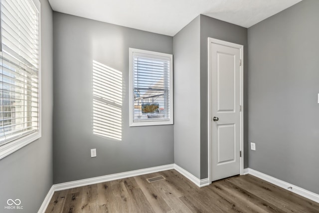 empty room with wood-type flooring