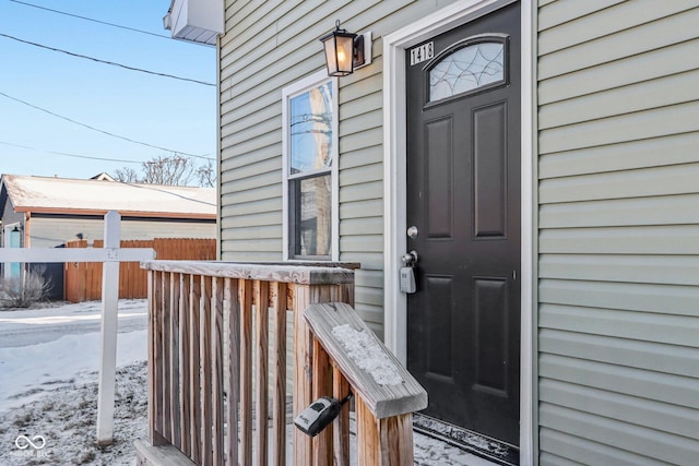 view of snow covered property entrance