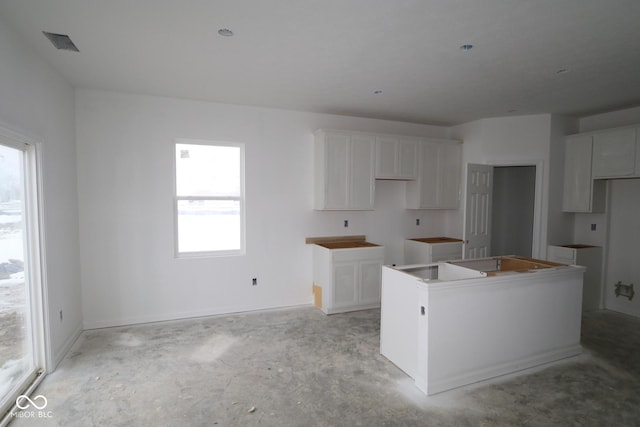 kitchen with white cabinetry and a center island