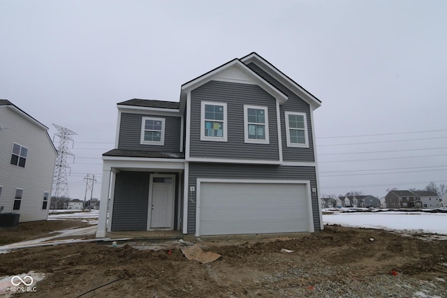 front of property with a garage and cooling unit