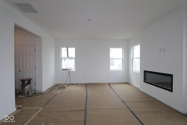 unfurnished living room featuring plenty of natural light