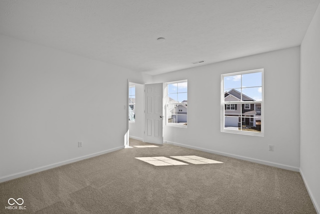 spare room featuring baseboards and carpet