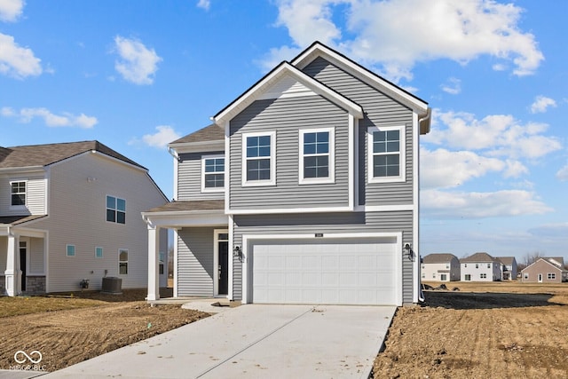 view of front facade with central AC unit, an attached garage, and driveway