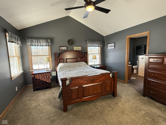 bedroom with lofted ceiling, connected bathroom, carpet, and ceiling fan