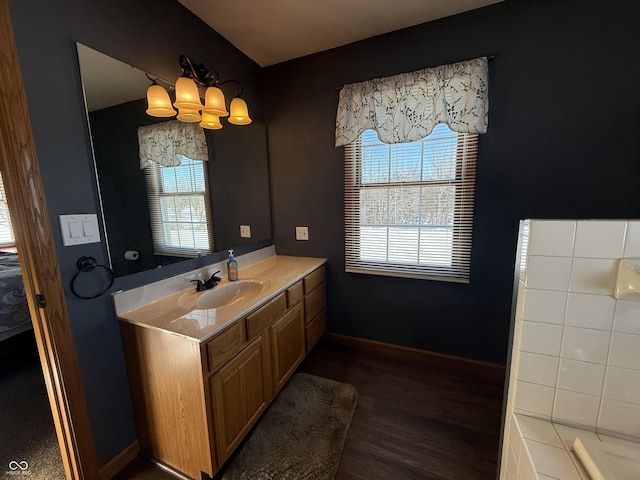 bathroom featuring vanity, hardwood / wood-style floors, and an inviting chandelier