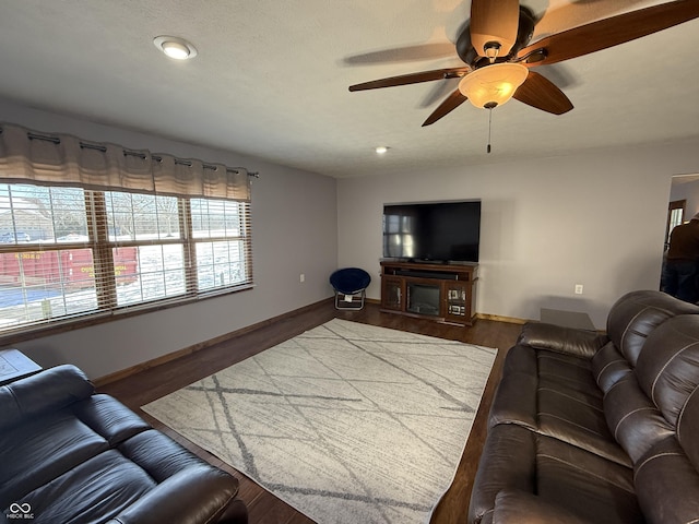 living room featuring ceiling fan and hardwood / wood-style floors